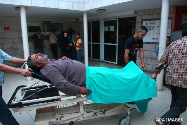 Mahmoud Abu Reiade, a Palestinian who was wounded in a confrontation with Israeli settlers in the village of Qusra, is brought to a hospital in the West Bank city of Nablus, Friday, Sept. 16, 2011. Israeli settlers assau...