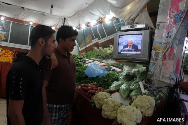 Customers in a Gaza mall watch TV as Palestinian Authority President Mahmud Abbas delivers a key speech ahead of the UN general assembly on September 16, 2011. Abbas said Palestinians are going to Security Council with U...