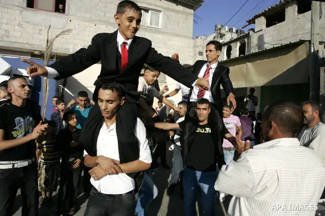 Palestinian friends and relatives celebrated the groom, Mohamed Gouda 24 years old, in the Rafah refugee camp, southern Gaza Strip on the eve of his wedding on Sep. 16, 2011, during the traditional celebration, Gouda was...