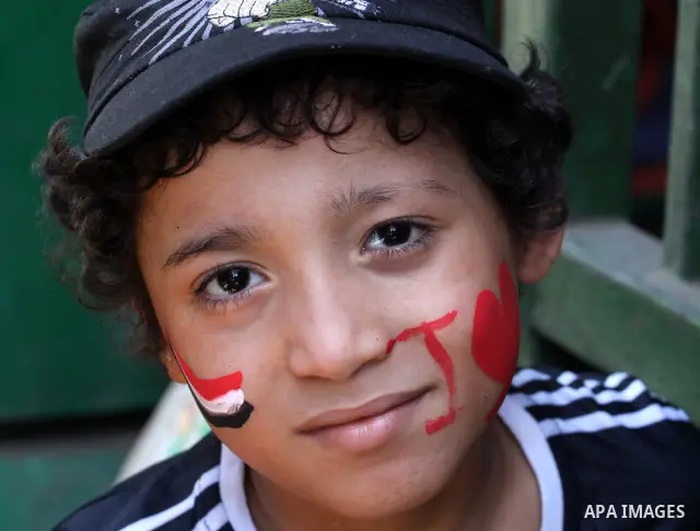 An Egyptian boy paints the Egyptian flag on his face at Tahrir Square while hundreds of Egyptians demonstrate against the expansion of the Emergency Law at Al Tahrir Square. The law allows censorship, government imprison...