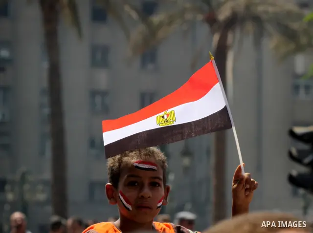 An Egyptian boy waves the Egyptian flag at Tahrir Square while hundreds of Egyptians demonstrate against the expansion of the Emergency Law at Al Tahrir Square. The law allows censorship, government imprisonment and more...