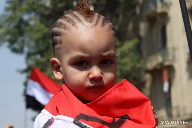 An Egyptian child wears the Egyptian flag at Tahrir Square while hundreds of Egyptians demonstrate against the expansion of the Emergency Law at Al Tahrir Square. The law allows censorship, government imprisonment and mo...