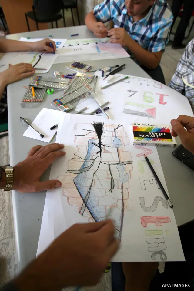 Palestinian students take part in a drawing session as part of a campaign calling for a Palestinian state with full UN membership at a school in the West Bank city of Nablus on September 17, 2011, as the Palestinians are...