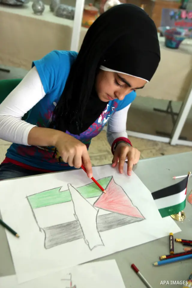 Palestinian students take part in a drawing session as part of a campaign calling for a Palestinian state with full UN membership at a school in the West Bank city of Nablus on September 17, 2011, as the Palestinians are...