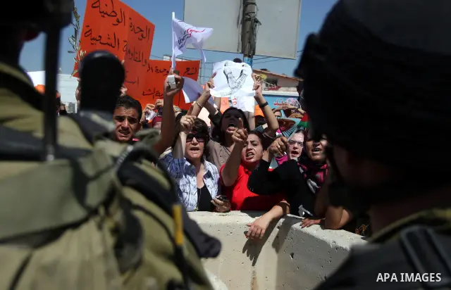 Palestinians wave national flags during a protest calling for a Palestinian state with full UN membership at the Qalandia Israeli checkpoint in the West Bank, near Ramallah, on Sep. 17, 2011. The Palestinians are prepari...