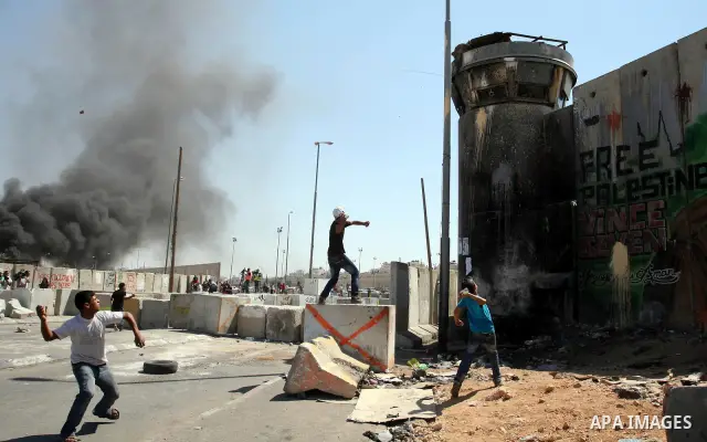 Palestinian youths throw stones at Israeli forces during a protest calling for a Palestinian state with full UN membership at the Qalandia Israeli checkpoint in the West Bank, near Ramallah, on Sep. 17, 2011. The Palesti...
