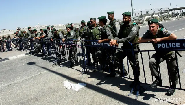 Israeli border police are looking on a smoke caused by burning tires during a demonstration calling for a Palestinian state with full UN membership in Jerusalem, on 17 September 2011. Palestine is set to submit a formal...