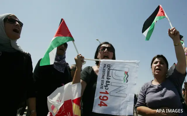 Palestinian women, joined by foreign peace activists and left-wing Israelis, hold up placards calling for a Palestinian state with full UN membership during a protest in Jerusalem, on 17 September 2011. Palestine is set...
