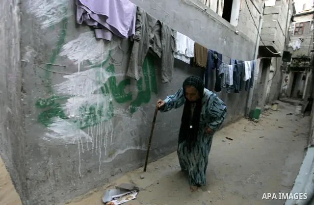 A Palestinian woman walks outside her house at Rafah refugee camp, southern Gaza Strip on Sep. 17, 2011. The Palestinians are preparing to submit a formal request to become the 194th member of the United Nations when the...