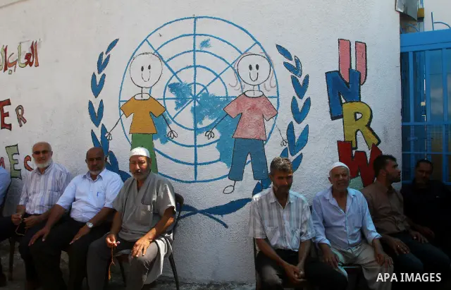 Palestinians take part in a protest in front of the UNRWA headquarters, against reducing the services provided to Palestine refugees in Gaza city, on Sep. 18, 2011. Photo by Ashraf Amra