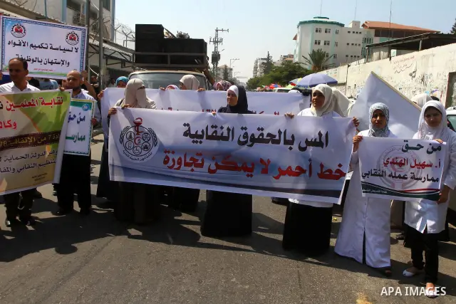 Palestinians take part in a protest in front of the UNRWA headquarters, against reducing the services provided to Palestine refugees in Gaza city, on Sep. 18, 2011. Photo by Ashraf Amra
