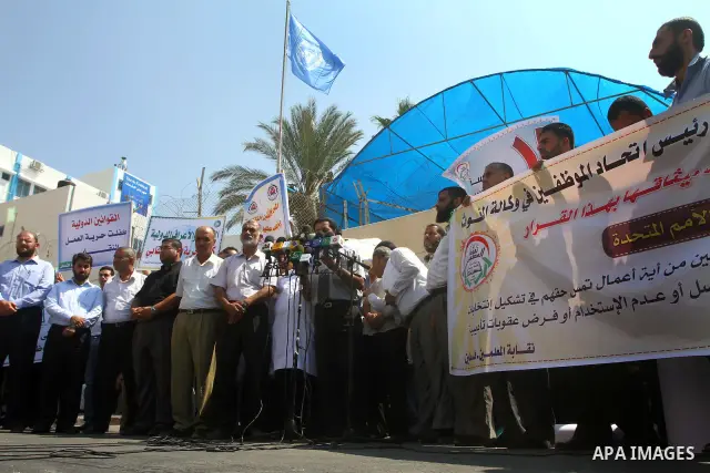 Palestinians take part in a protest in front of the UNRWA headquarters, against reducing the services provided to Palestine refugees in Gaza city, on Sep. 18, 2011. Photo by Ashraf Amra