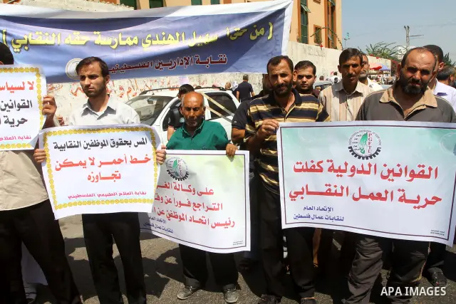 Palestinians take part in a protest in front of the UNRWA headquarters, against reducing the services provided to Palestine refugees in Gaza city, on Sep. 18, 2011. Photo by Ashraf Amra