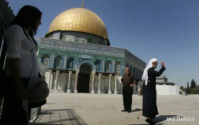 A Palestinian man walks in front of the Dome of the Rock in Old Jerusalem's as a group of Jews touring a Jerusalem site holy to Judaism and Islam on September 18, 2011 were confronted by angry Muslim cries of "Allahu Akb...