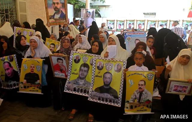 Palestinian women hold pictures of their prisoned relatives in Israeli jails as they gather in a weekly activity calling for their liberty at the Red Cross headquarters in Gaza City on Sep. 19, 2011. About 7000 prisoners...