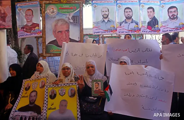 Palestinian women hold pictures of their prisoned relatives in Israeli jails as they gather in a weekly activity calling for their liberty at the Red Cross headquarters in Gaza City on Sep. 19, 2011. About 7000 prisoners...