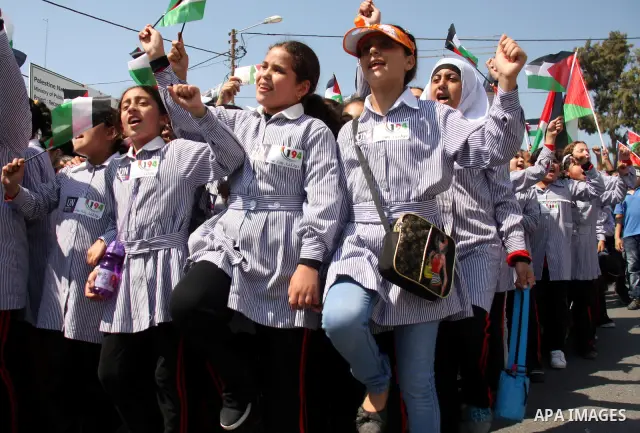 Palestinian schoolchildren hold their national flag during a rally in the West Bank city of Tulkarem, Monday, Sept. 19, 2011. Abbas is set to address the U.N. this week, planning to ask the world to recognize a Palestini...