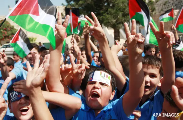 Palestinian schoolchildren hold their national flag during a rally in the West Bank city of Tulkarem, Monday, Sept. 19, 2011. Abbas is set to address the U.N. this week, planning to ask the world to recognize a Palestini...