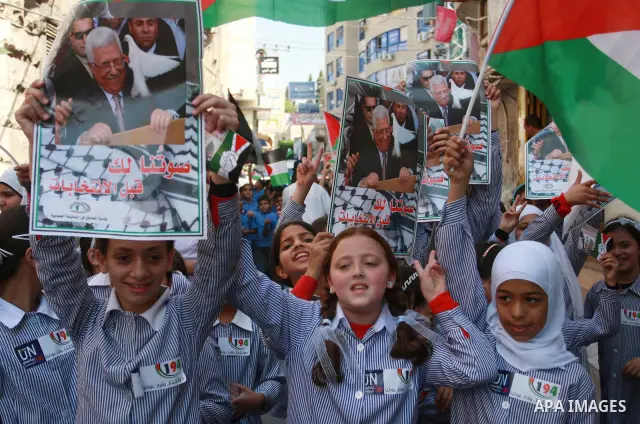 Palestinian schoolchildren hold their national flag during a rally in the West Bank city of Tulkarem, Monday, Sept. 19, 2011. Abbas is set to address the U.N. this week, planning to ask the world to recognize a Palestini...