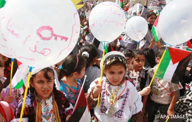 Palestinian schoolchildren hold their national flag during a rally in the West Bank city of Tulkarem, Monday, Sept. 19, 2011. Abbas is set to address the U.N. this week, planning to ask the world to recognize a Palestini...