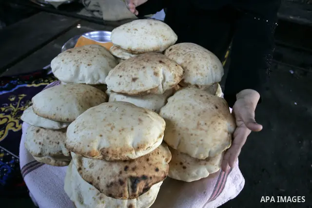 A Palestinian woman bakes bread in a traditional mud oven in Rafah refugee camp, southern Gaza Strip on September 19, 2011. A diplomatic showdown looms at the United Nations this month when Palestinian President Mahmoud...