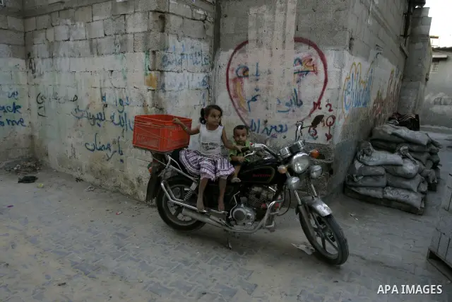 Palestinian children sit on a motorcycle in the Rafah refugee camp, southern Gaza Strip on Sep. 19, 2011. Attend the 66th General Assembly session of United Nations, which begins Tuesday, Sep. 20. The United States and E...