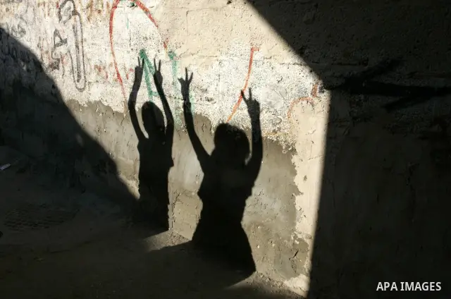 A shadow of Palestinian children display a sign of victory on a wall in the Rafah refugee camp, southern Gaza Strip on Sep. 19, 2011. Attend the 66th General Assembly session of United Nations, which begins Tuesday, Sep....
