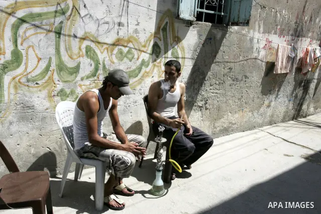 Palestinian youths smoke a water pipe in the Rafah refugee camp, southern Gaza Strip on Sep. 19, 2011. Attend the 66th General Assembly session of United Nations, which begins Tuesday, Sep. 20. The United States and Euro...