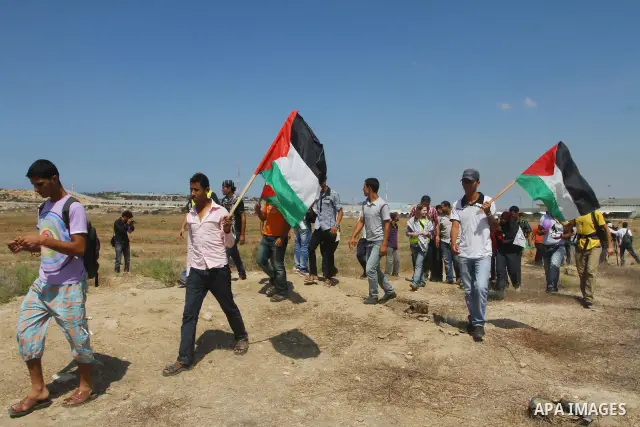 Palestinian and foreign activists take part in a rally in support of the Palestinian UN bid for statehood near the fence separating Israel from the Gaza Strip, in Beit Hanun, on September 20, 2011. The Palestinians are p...