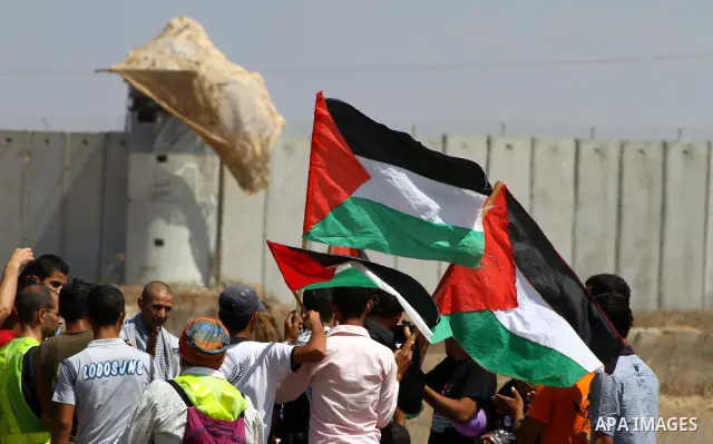 Palestinian and foreign activists take part in a rally in support of the Palestinian UN bid for statehood near the fence separating Israel from the Gaza Strip, in Beit Hanun, on September 20, 2011. The Palestinians are p...