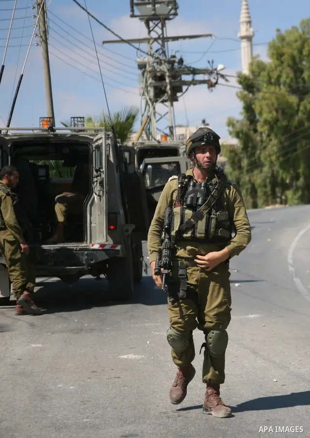 Israeli troops take position in the West Bank village of Beit Omar, near Hebron during clashes with Palestinians on 20 September 2011. President Mahmoud Abbas intends to make a bid on 23 September for United Nations memb...