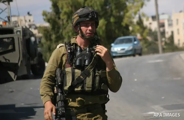 Israeli troops take position in the West Bank village of Beit Omar, near Hebron during clashes with Palestinians on 20 September 2011. President Mahmoud Abbas intends to make a bid on 23 September for United Nations memb...