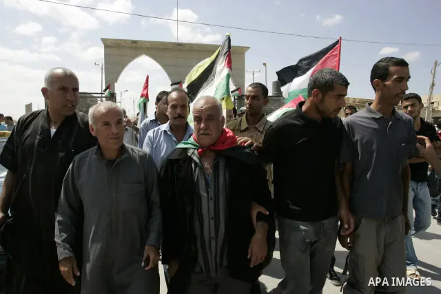 Palestinians receive their relative Khalil Abu Zarifa, 65, who left Gaza Strip for 45 years in front of the Rafah border crossing in the southern Gaza Strip on Sep. 20,2011. Palestinians are preparing to submit a formal...
