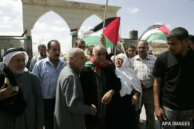 Palestinians receive their relative Khalil Abu Zarifa, 65, who left Gaza Strip for 45 years in front of the Rafah border crossing in the southern Gaza Strip on Sep. 20,2011. Palestinians are preparing to submit a formal...