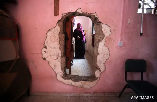 A Palestinian woman works at her house in the Jabaliya refugee camp in the northern area of the Gaza Strip on 20 September 2011. A diplomatic showdown looms at the United Nations this month when Palestinian President Mah...
