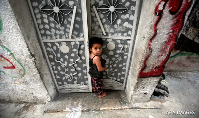 A Palestinian child plays in front of their house in the Jabaliya refugee camp in the northern area of the Gaza Strip on 20 September 2011. A diplomatic showdown looms at the United Nations this month when Palestinian Pr...