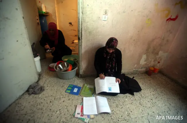 A Palestinian woman works at her house in the Jabaliya refugee camp in the northern area of the Gaza Strip on 20 September 2011. A diplomatic showdown looms at the United Nations this month when Palestinian President Mah...