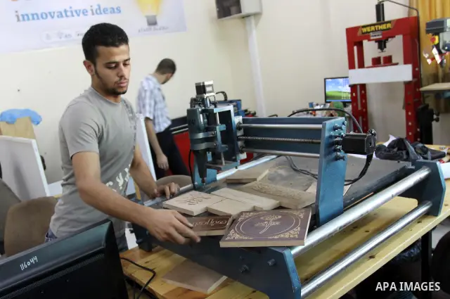 A Palestinian engineering collage student works on hand-made machine at the Islamic University in Gaza city on Sep. 20,2011.l. Photo by Mohammed Asad