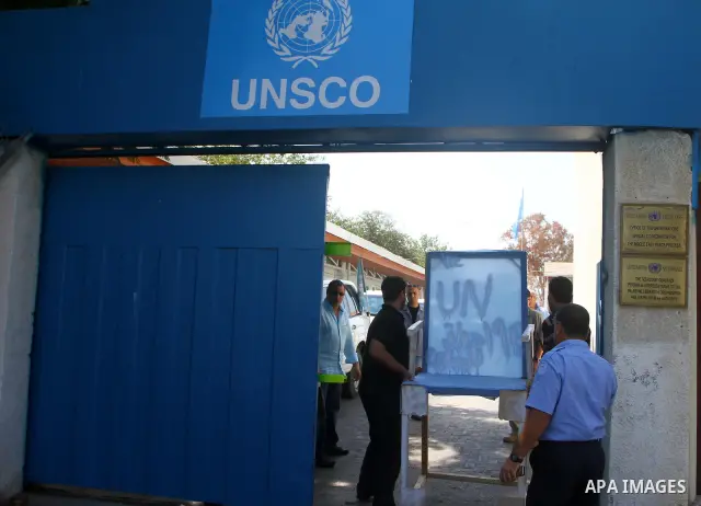 Palestinian carpenter Mustafa Masoud, 24, takes a chair symbolizing the Palestinian statehood bid from his house to be placed in front of the UN offices in Gaza city, Wednesday, Sept. 21, 2011. Writing in Arabic reads "P...