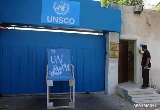 Palestinian carpenter Mustafa Masoud, 24, takes a chair symbolizing the Palestinian statehood bid from his house to be placed in front of the UN offices in Gaza city, Wednesday, Sept. 21, 2011. Writing in Arabic reads "P...