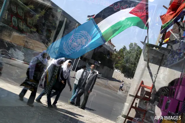 A Palestinian and UN flag flutter outside a souvenirs shop in Gaza City in support of Palestinian President Mahmoud Abbas' bid for statehood cin the United Nations on September 21, 2011. Abbas plans on Friday to submit a...