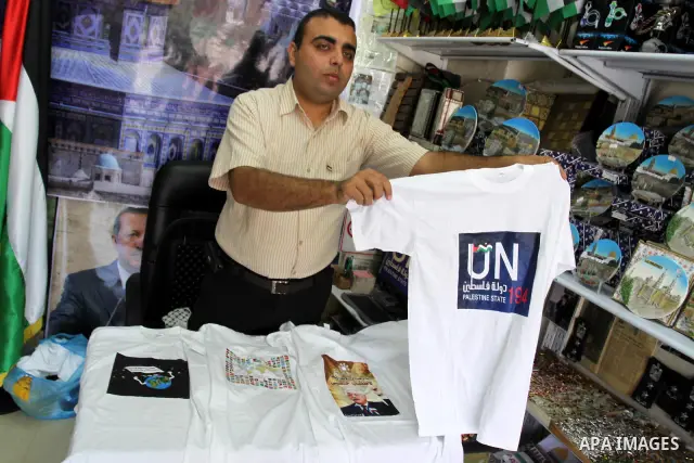 A Palestinian vendor displays the United Nation logo on a shirts, in support of Palestinian President Mahmoud Abbas' bid for statehood recognition in the United Nations on September 21, 2011. Abbas plans on Friday to sub...