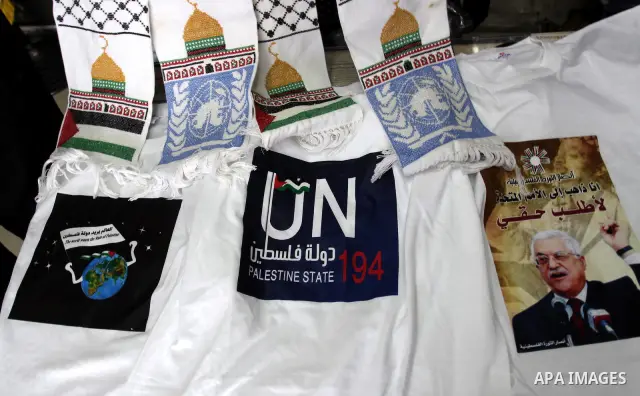 A Palestinian vendor displays the United Nation logo on a shirts, in support of Palestinian President Mahmoud Abbas' bid for statehood recognition in the United Nations on September 21, 2011. Abbas plans on Friday to sub...