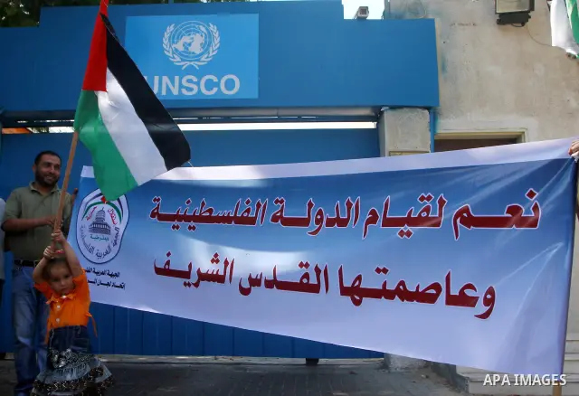 Palestinians hold posters during a demonstration in support of Palestinian leader Mahmud Abbas' bid for statehood recognition at the United Nations on September 21, 2011 in Gaza City. Palestinians are preparing to submit...