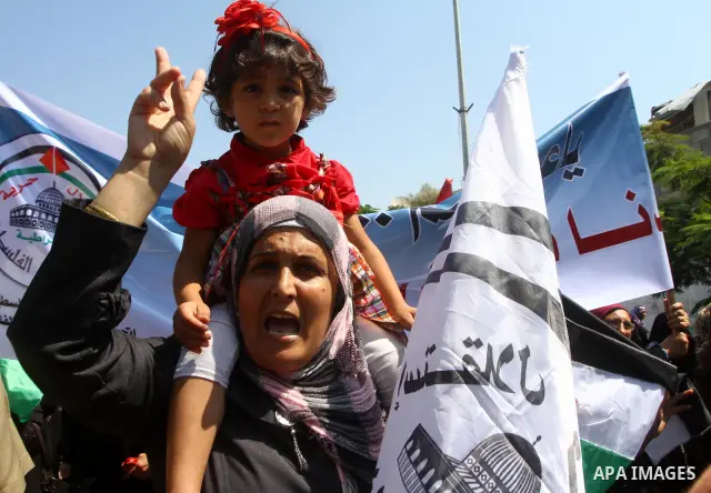 A Palestinian woman chants slogans during a demonstration in support of Palestinian leader Mahmud Abbas' bid for statehood recognition at the United Nations on September 21, 2011 in Gaza City. Palestinians are preparing...