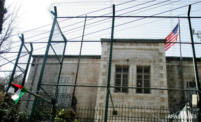 A Palestinian flag hangs on the fence of the US General Consulate in east Jerusalem during a protest against US' interference in the Palestinian bid for statehood recognition at the United Nations on September 21, 2011....