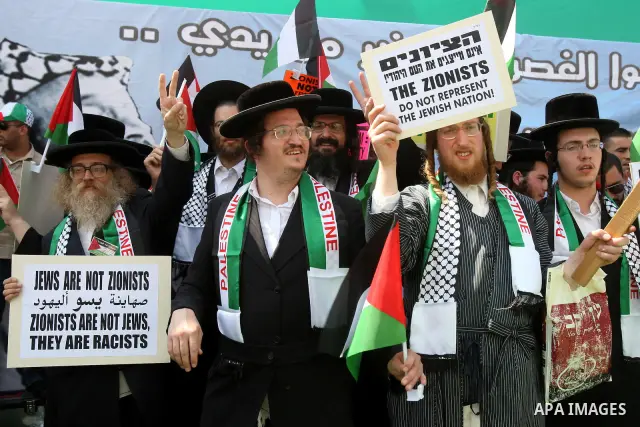 Members of Neturei Karta, a small faction of ultra-Orthodox Jews who oppose Israel's existence,wave Palestinian flags to express support for the Palestinian bid for statehood recognition at the United Nations as thousand...