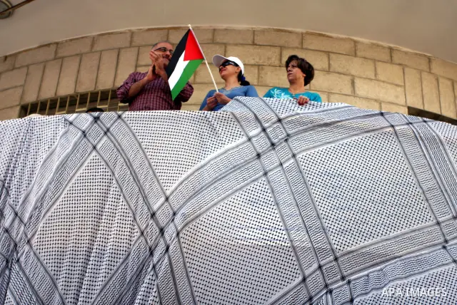 Palestinians participate in a rally in support of the Palestinian bid for statehood recognition in the United Nations, in the West Bank city of Ramallah, Wednesday, Sept. 21, 2011. Thousands of flag-waving Palestinians r...