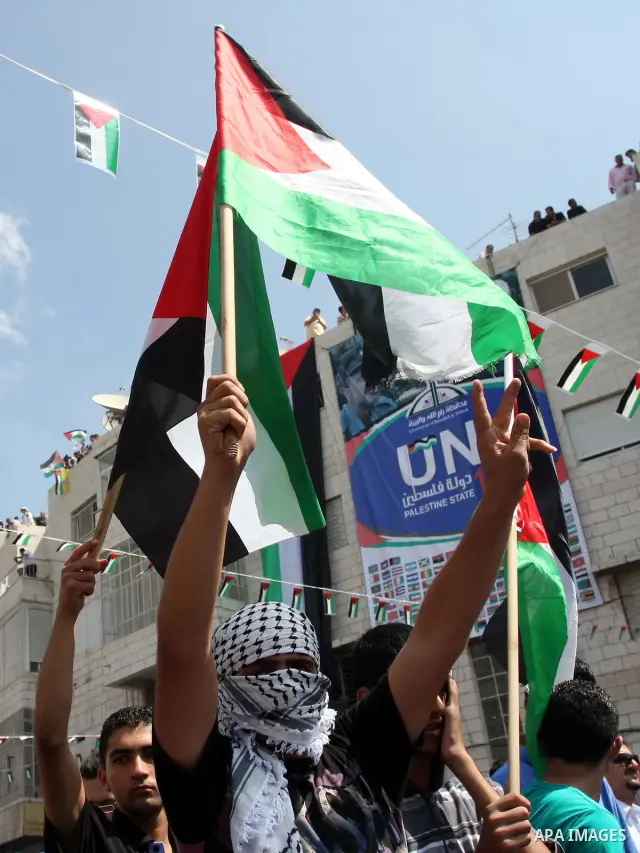 Palestinians participate in a rally in support of the Palestinian bid for statehood recognition in the United Nations, in the West Bank city of Ramallah, Wednesday, Sept. 21, 2011. Thousands of flag-waving Palestinians r...