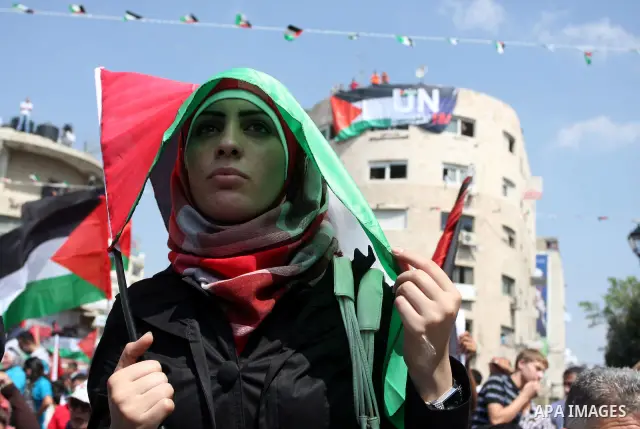 Palestinians participate in a rally in support of the Palestinian bid for statehood recognition in the United Nations, in the West Bank city of Ramallah, Wednesday, Sept. 21, 2011. Thousands of flag-waving Palestinians r...
